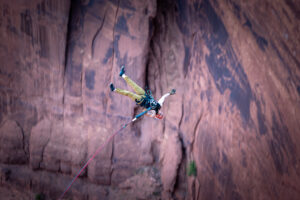 Guest swinging through open air on the Moab Rope Swing