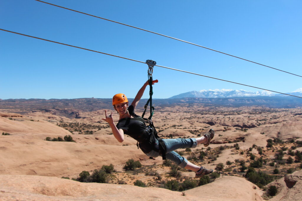 Happy zipliner enjoying guided zipline tour in Moab