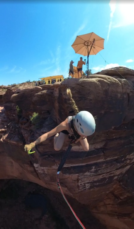 Spectators watching rope swing participant near Moab