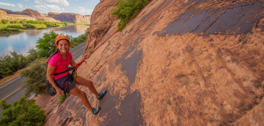 Smiling rock climber on guided Moab climbing tour