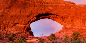 Guests overlooking Arches National Park at sunset