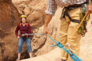 First time guest learning to rappel during guided Moab canyoneering tour