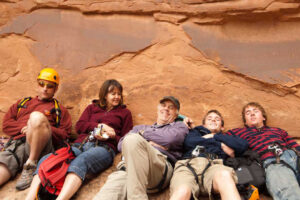 Family resting during guided canyoneering tour in Moab Utah