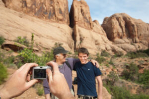 Father and son on Moab canyoneering adventure near Morning Glory Arch