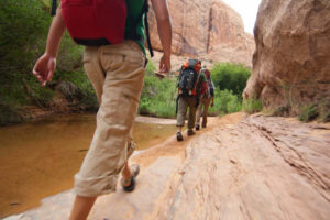 Canyoneering group hiking through desert wash near Moab Utah