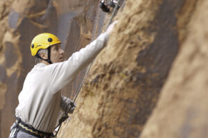 Rock climber preparing hands with chalk in Moab Utah