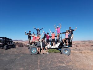 guests celebrating on top of modified 4x4 during Moab off-road tour