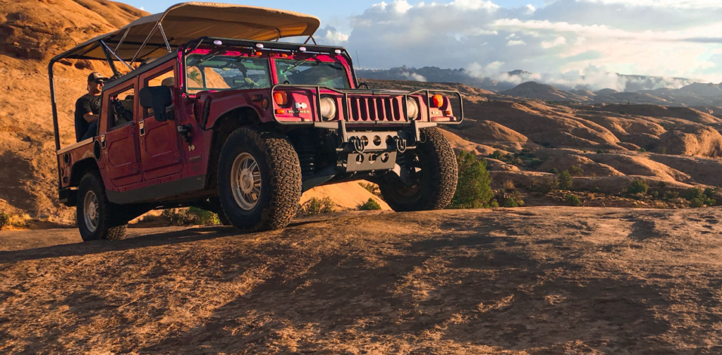 Hummer climbing steep slickrock hill on Hell’s Revenge trail